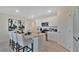 Modern kitchen island with granite countertops and seating for four at 1249 Limbali St, Mount Dora, FL 32757