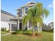 Two-story house with a front porch and palm tree in the front yard at 1455 Williams Rd, Winter Garden, FL 34787