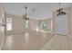 Spacious living room with tile flooring, a chandelier, and large windows providing natural light at 1984 Westpointe Cir, Orlando, FL 32835