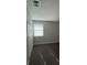 Empty bedroom with gray carpet, white walls, closet doors, and window with blinds at 2220 Menomonee Ct, Orlando, FL 32818