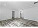 Open living room with gray vinyl plank flooring and views of bath at 2239 Crawford St, Mascotte, FL 34753