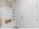 White bench with storage and shelves in entryway at 2326 Daisy Tree Rd, St Cloud, FL 34771