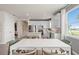 Bright dining area with white table and green chairs, adjacent to kitchen at 2326 Daisy Tree Rd, St Cloud, FL 34771