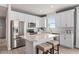 Modern kitchen with white cabinets, island, and stainless steel appliances at 2326 Daisy Tree Rd, St Cloud, FL 34771