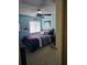 Bedroom with purple bedding, ceiling fan, and a window at 3563 S Saint Lucie Dr, Casselberry, FL 32707