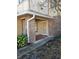 Inviting entryway with tiled porch, brick accents, and lush landscaping at 3563 S Saint Lucie Dr, Casselberry, FL 32707