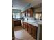 Galley kitchen with wood cabinets and light countertops at 3563 S Saint Lucie Dr, Casselberry, FL 32707