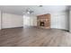 Bright living room features a brick fireplace, wood-look floors, and large windows at 3805 N Lake Orlando Pkwy, Orlando, FL 32808