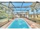 Inviting pool area enclosed by a screen enclosure at 451 Seminole St, Clermont, FL 34711