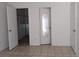 Condo bedroom with tiled floor and mirrored closet doors at 4818 S Semoran Blvd # 508, Orlando, FL 32822