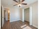 View of the bedroom with wood-look floors, ceiling fan, and closet at 4901 Leprechaun Way, Orlando, FL 32808