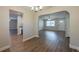 Open dining room with wood-look floors and arched entryway at 4901 Leprechaun Way, Orlando, FL 32808