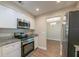 View of the updated kitchen with stainless steel appliances and white cabinetry at 4901 Leprechaun Way, Orlando, FL 32808