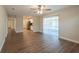 Spacious living room with wood-look flooring, ceiling fan, and access to the kitchen at 4901 Leprechaun Way, Orlando, FL 32808