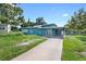 Cute teal single story home with a long driveway at 6113 Medford Ct, Orlando, FL 32808