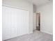 Bedroom with grey carpet and double door closet at 6595 Lullaby Way, Mascotte, FL 34753