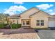 Exterior view of the house with a paved driveway and front yard landscaping at 995 David Walker Dr, Tavares, FL 32778