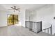 Bright loft area with gray flooring and black railing at 1315 Wheeler Rd, Apopka, FL 32703