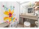 Clean bathroom with floral shower curtain and updated vanity at 151 E Washington St # 201, Orlando, FL 32801