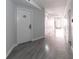 Clean hallway with light gray walls and wood-look flooring at 151 E Washington St # 201, Orlando, FL 32801