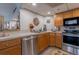 Modern kitchen with stainless steel appliances and wood cabinets at 151 E Washington St # 201, Orlando, FL 32801