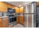 Modern kitchen with stainless steel appliances and wood cabinets at 151 E Washington St # 201, Orlando, FL 32801