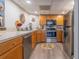 Modern kitchen with stainless steel appliances and wood cabinets at 151 E Washington St # 201, Orlando, FL 32801