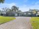 Updated home with paver driveway, landscaping, and basketball court at 3606 Ibis Dr, Orlando, FL 32803