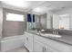 Bathroom with double vanity, bathtub, and gray tile at 4241 Paragraph Dr, Kissimmee, FL 34746