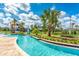 Lazy river pool with palm trees and a waterslide at 4241 Paragraph Dr, Kissimmee, FL 34746