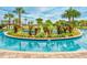 Lazy river with lush landscaping and wooden bridge at 4241 Paragraph Dr, Kissimmee, FL 34746