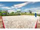 Outdoor sand volleyball court with nets and surrounding hedges at 4241 Paragraph Dr, Kissimmee, FL 34746