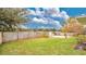 Fenced backyard with grassy area and mature trees at 45 Sackett Rd, Debary, FL 32713