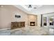 Bright living room featuring a stone fireplace and access to a patio at 45 Sackett Rd, Debary, FL 32713