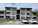 Two-story condo building with parking and landscaping at 4601 Cason Cove Dr # 214, Orlando, FL 32811