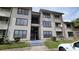 Condo building entrance with stairs and landscaping at 4601 Cason Cove Dr # 214, Orlando, FL 32811