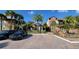 Two-story condo building with palm trees and a paved parking lot at 4601 Cason Cove Dr # 214, Orlando, FL 32811