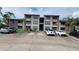 Two-story building exterior with ample parking at 4601 Cason Cove Dr # 214, Orlando, FL 32811