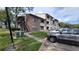 Side view of condo building with stairs and parking at 4601 Cason Cove Dr # 214, Orlando, FL 32811