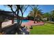 Community pool with surrounding landscaping and seating at 4601 Cason Cove Dr # 214, Orlando, FL 32811