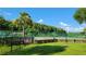 Community tennis court with lush greenery at 4601 Cason Cove Dr # 214, Orlando, FL 32811