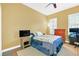 Bright bedroom with a double bed, dresser, and TV at 513 Mirasol Cir # 101, Celebration, FL 34747