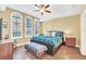 Bright bedroom featuring a king-size bed and hardwood floors at 513 Mirasol Cir # 101, Celebration, FL 34747
