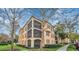 Tan three-story building with balconies and lush landscaping at 513 Mirasol Cir # 101, Celebration, FL 34747