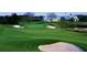 Green golf course with sand traps and clubhouse at 513 Mirasol Cir # 101, Celebration, FL 34747