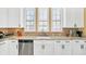 Modern kitchen with white cabinets, granite countertops, and stainless steel appliances at 513 Mirasol Cir # 101, Celebration, FL 34747