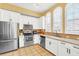 Well-equipped kitchen featuring stainless steel appliances and white cabinetry at 513 Mirasol Cir # 101, Celebration, FL 34747