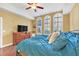 Main bedroom with hardwood floors, a dresser, and a large bed at 513 Mirasol Cir # 101, Celebration, FL 34747