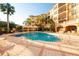 Community pool with plenty of lounge chairs and shade at 513 Mirasol Cir # 101, Celebration, FL 34747