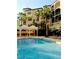 Resort-style pool with palm trees and lounge chairs at 513 Mirasol Cir # 101, Celebration, FL 34747